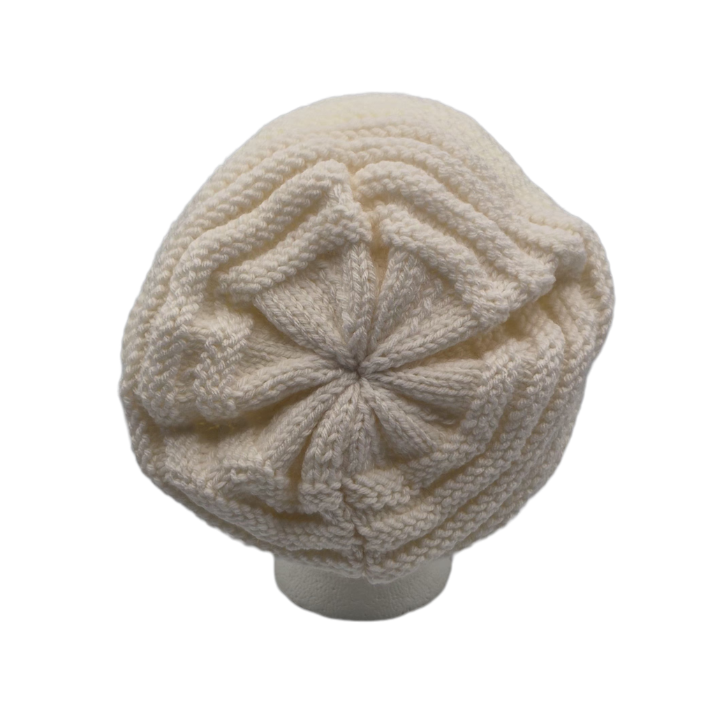 Cream white chunky knit slouchy beanie hat displayed on a white mannequin head.