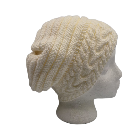 Cream cable-knit slouchy beanie hat displayed on a white mannequin head.