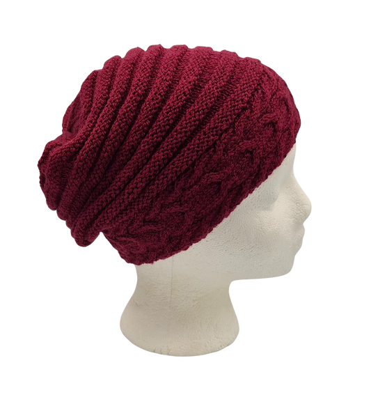 A deep burgundy knit slouchy beanie hat displayed on a white mannequin head.