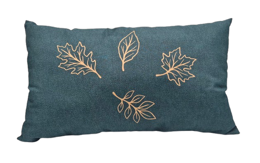 A rectangular green throw pillow featuring vinyl gold leaf designs.