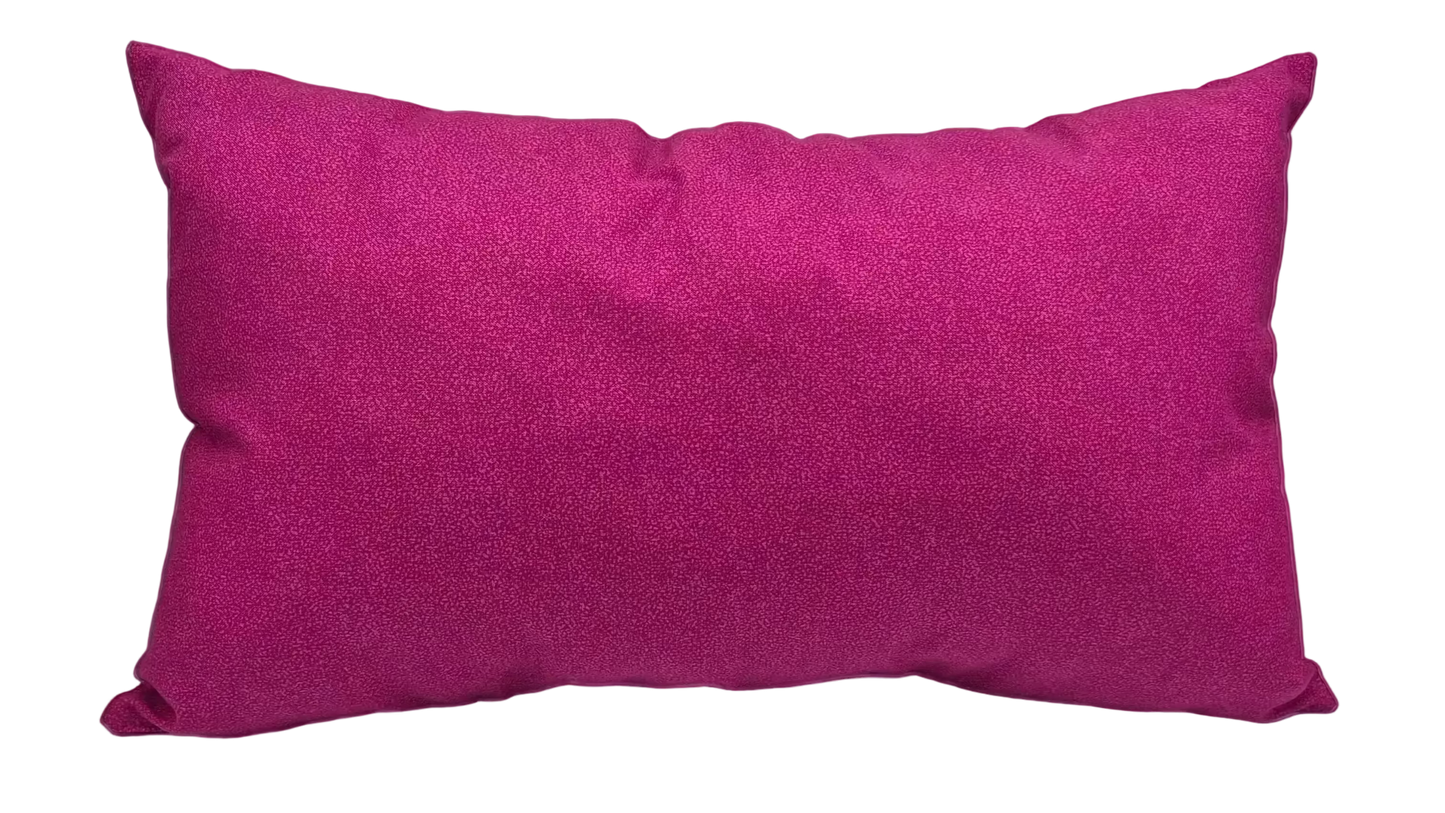 A rectangular magenta lumbar pillow with a textured fabric cover.