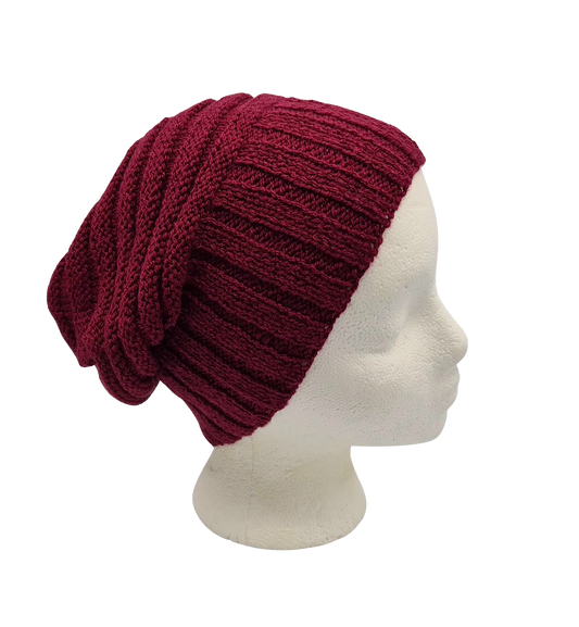 A burgundy ribbed knit slouchy beanie hat displayed on a white mannequin head.