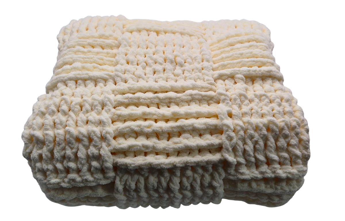 A chunky crocheted baby blanket in a warm cream color, featuring a textured basket weave pattern.