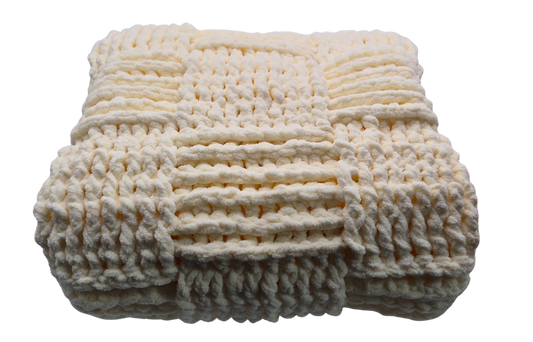 A chunky crocheted baby blanket in a warm cream color, featuring a textured basket weave pattern.