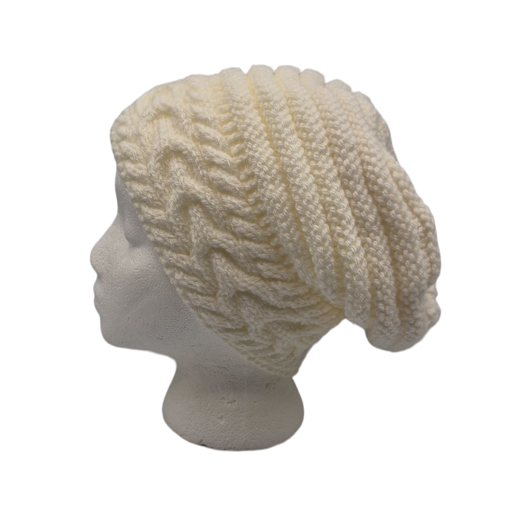 Cream white cable-knit slouchy beanie hat displayed on a white mannequin head.