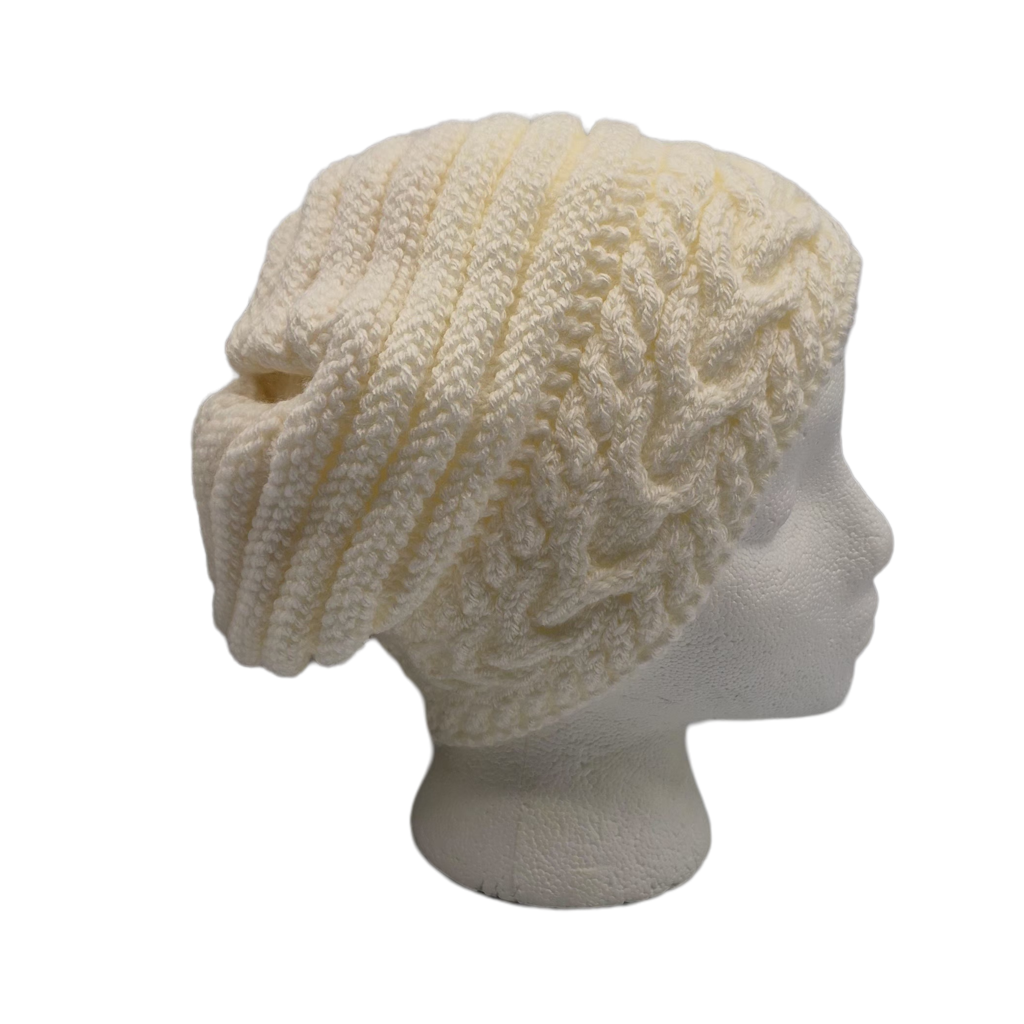 Cream cable-knit slouchy beanie hat displayed on a white mannequin head.