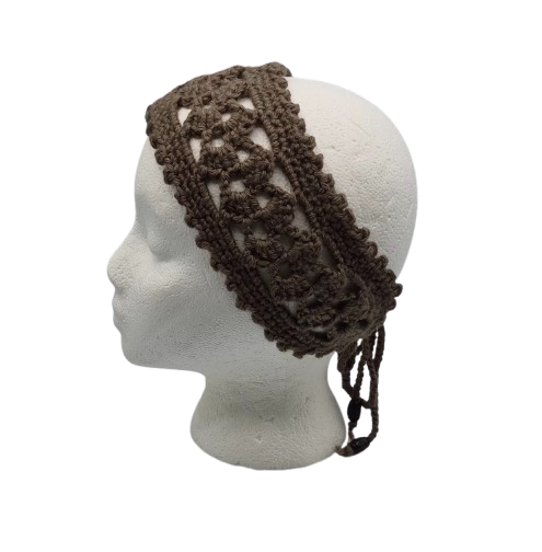 A dark brown crocheted headband with a textured openwork pattern and hanging ties, displayed on a white mannequin head.