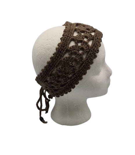 A dark brown crocheted headband with a lace-like openwork pattern and side ties, displayed on a white mannequin head.