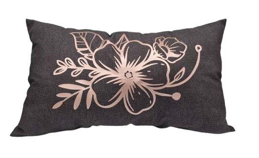 A rectangular dark charcoal gray throw pillow featuring a rose gold floral line art design on the front.