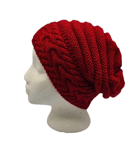 A deep red chunky cable-knit slouchy beanie hat displayed on a white mannequin head.
