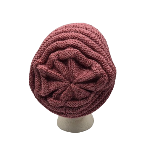 A dusty rose  chunky knit slouchy beanie hat displayed on a white mannequin head.