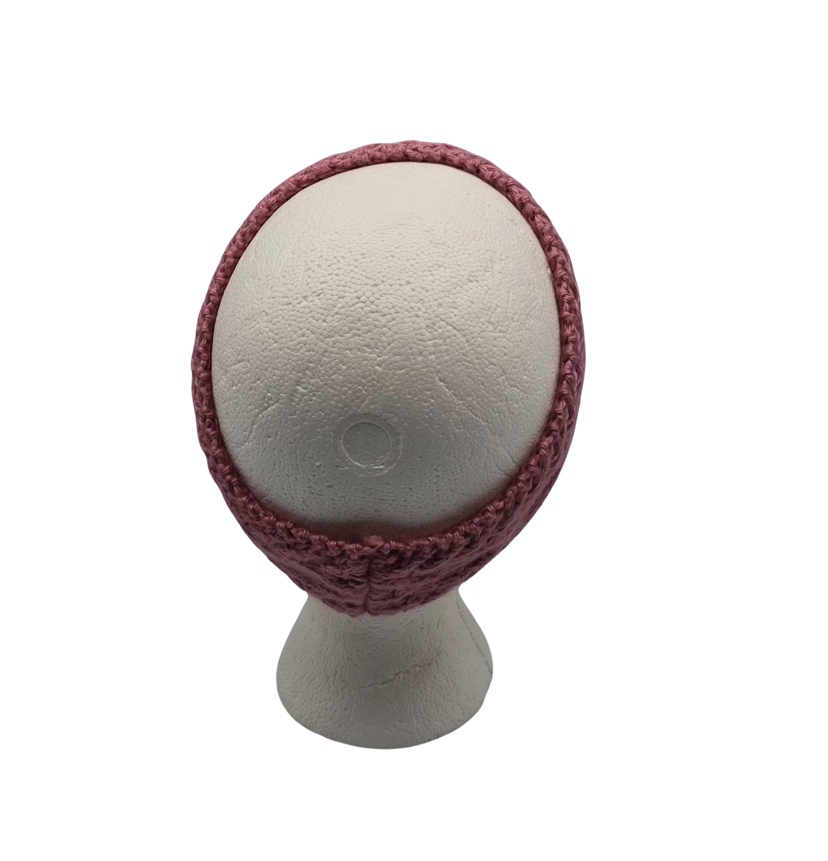 A dusty rose  cable knit headband displayed on a white mannequin head.