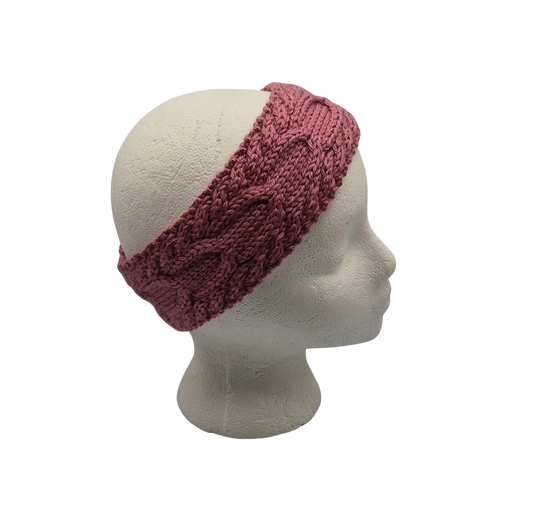 A dusty rose  cable-knit headband displayed on a white mannequin head.