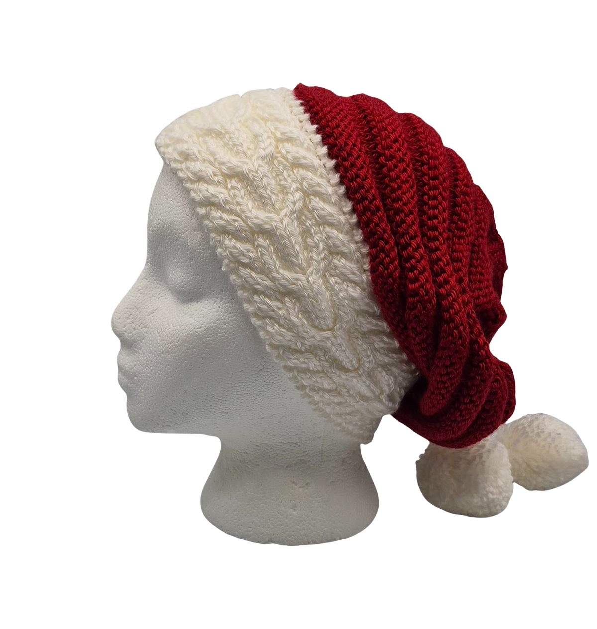 A red and white knit hat slouchy beanie with two pom-poms, displayed on a white mannequin head.