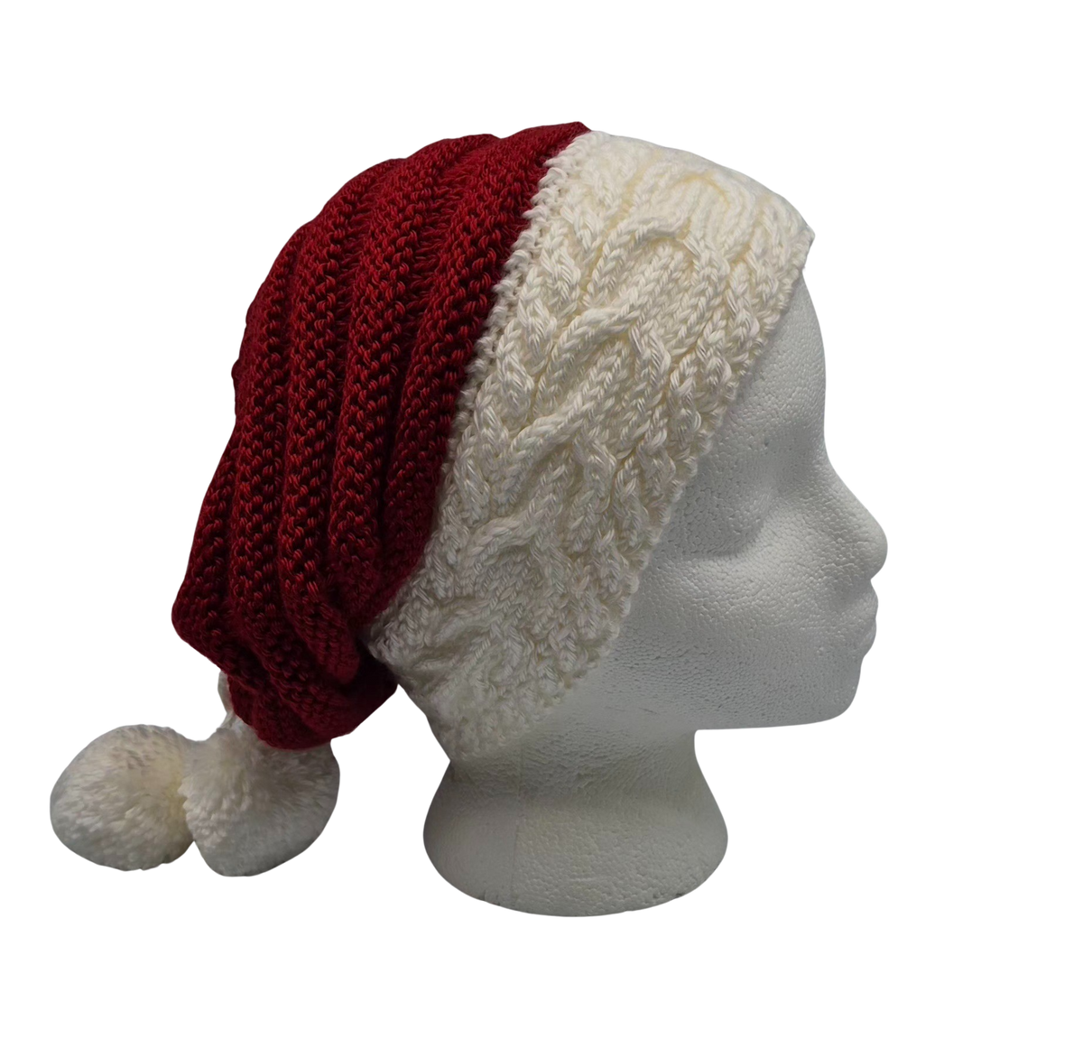 A red and white knit hat slouchy beanie with two pom-poms, displayed on a white mannequin head.