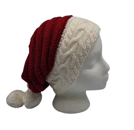 A red and white knit hat slouchy beanie with two pom-poms, displayed on a white mannequin head.
